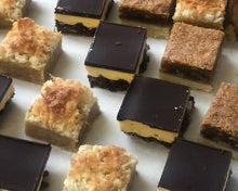 Load image into Gallery viewer, Close-up of assorted bite-sized dessert bars with chocolate and crumb toppings.