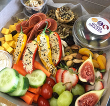 Load image into Gallery viewer, Close-up of plant-based cheese, vegan deli slices, fruit, vegetables and dip in the Vegan Grazing Box.